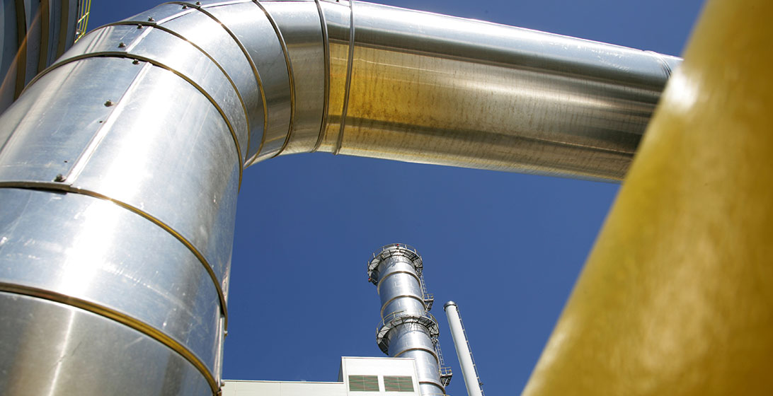 Photograph of  a large metal pipe outside a power station
