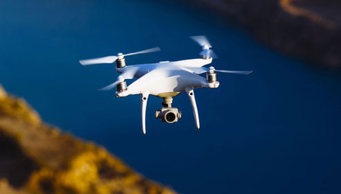 Photograph of a drone flying above a body of water