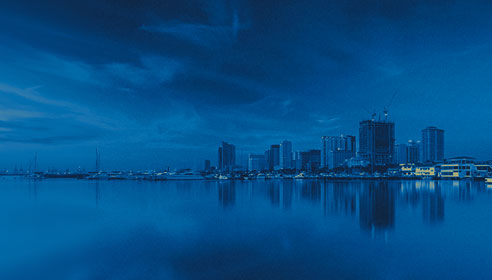 Photograph of a city scape with a dark blue overlay