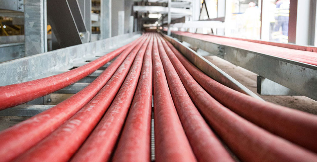 Close up photograph of thick red cables laid out on the floor