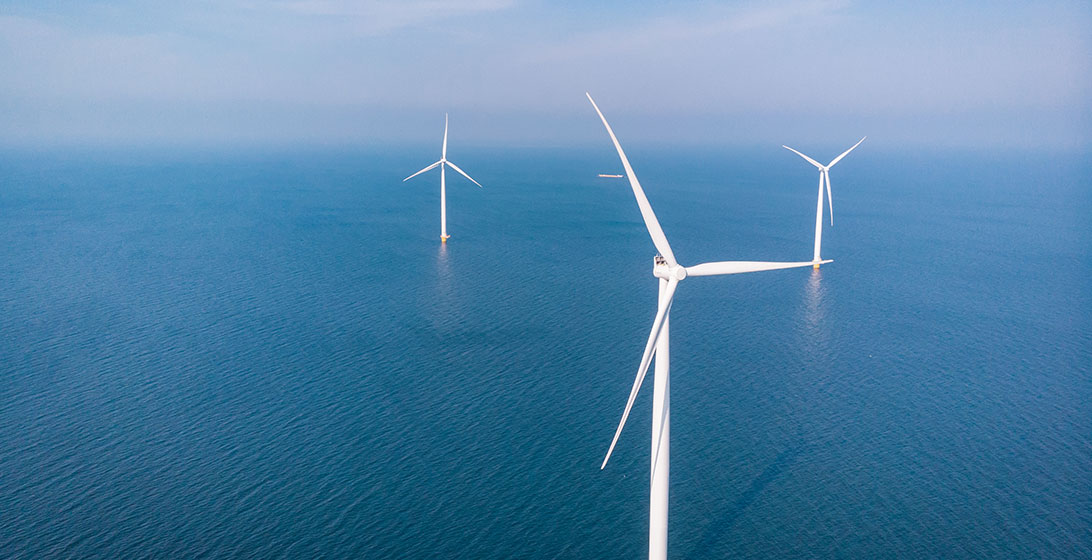 Photograph of an offshore wind farm showing wind turbines in the sea