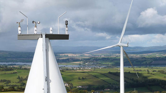 low-carbon-staggard-card Image of the propellers on a wind turbine with country side landscape in background